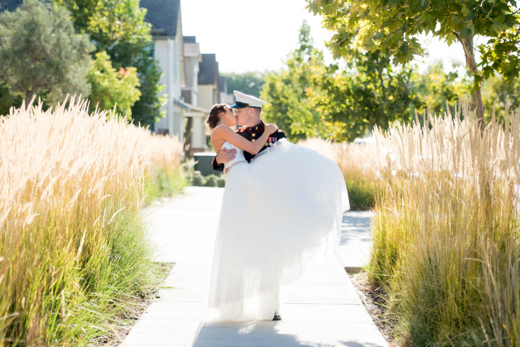 Veterans Day PIc- a marine holding his bride in his arms 