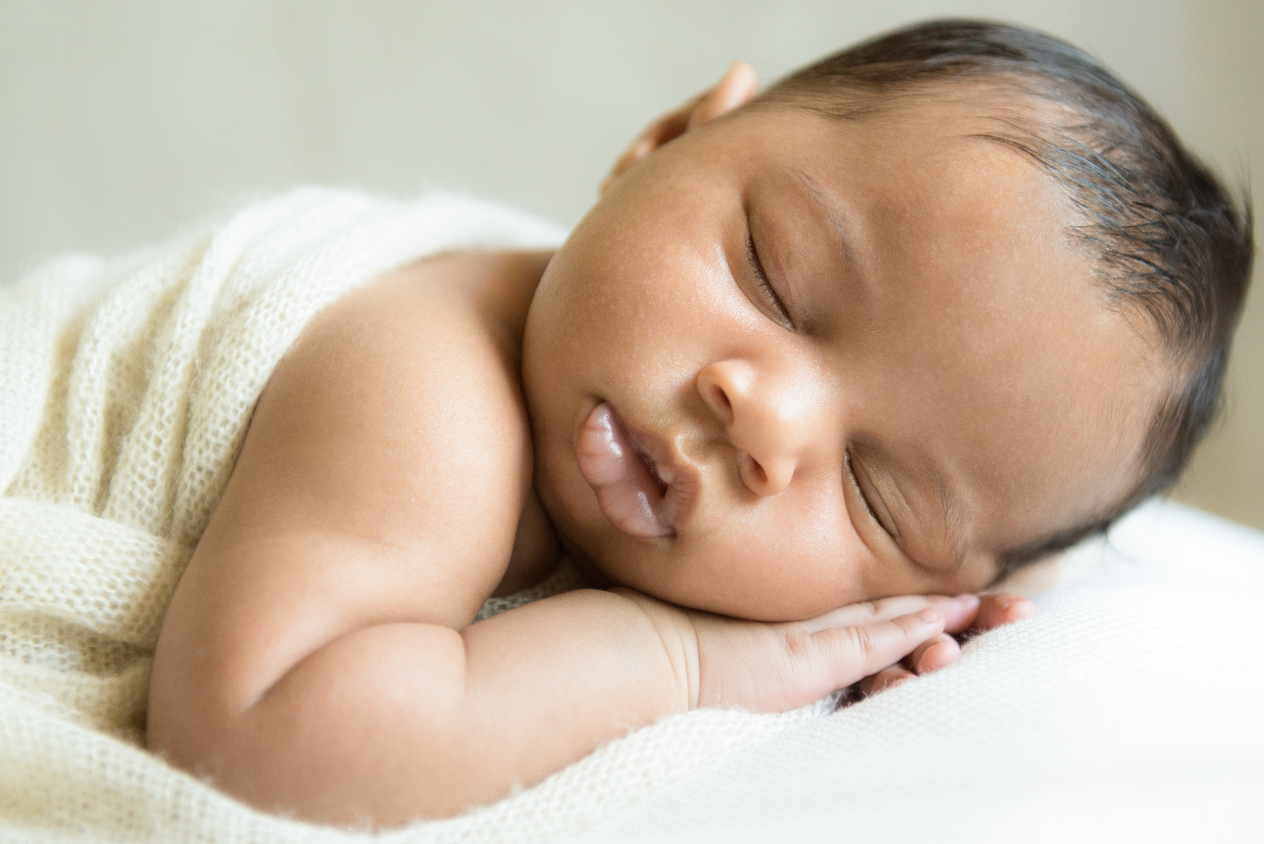 A sweet 9 week old baby girl poses for a picture