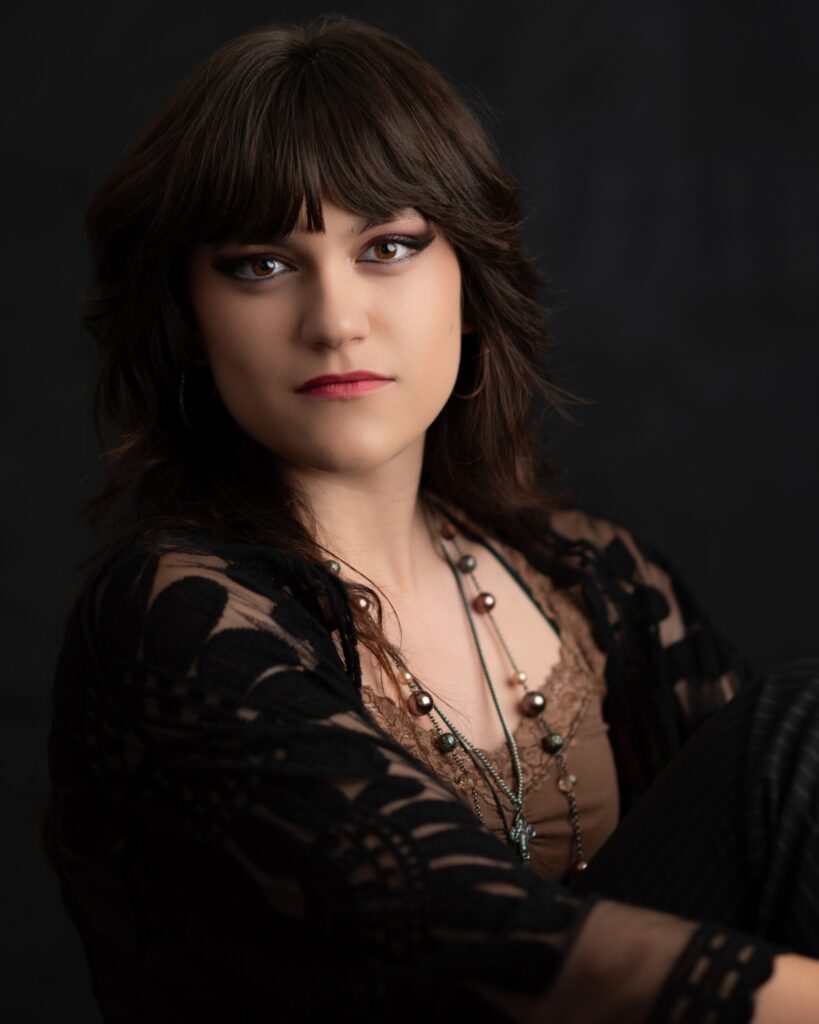 A female senior in high school poses in a photography studio in El Dorado Hills for Susannah Gill.